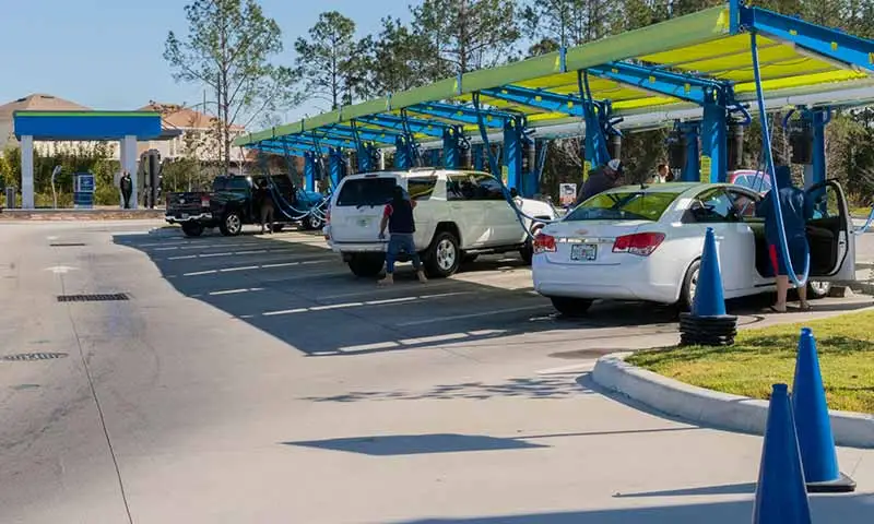 Line of customers using car wash vacuums